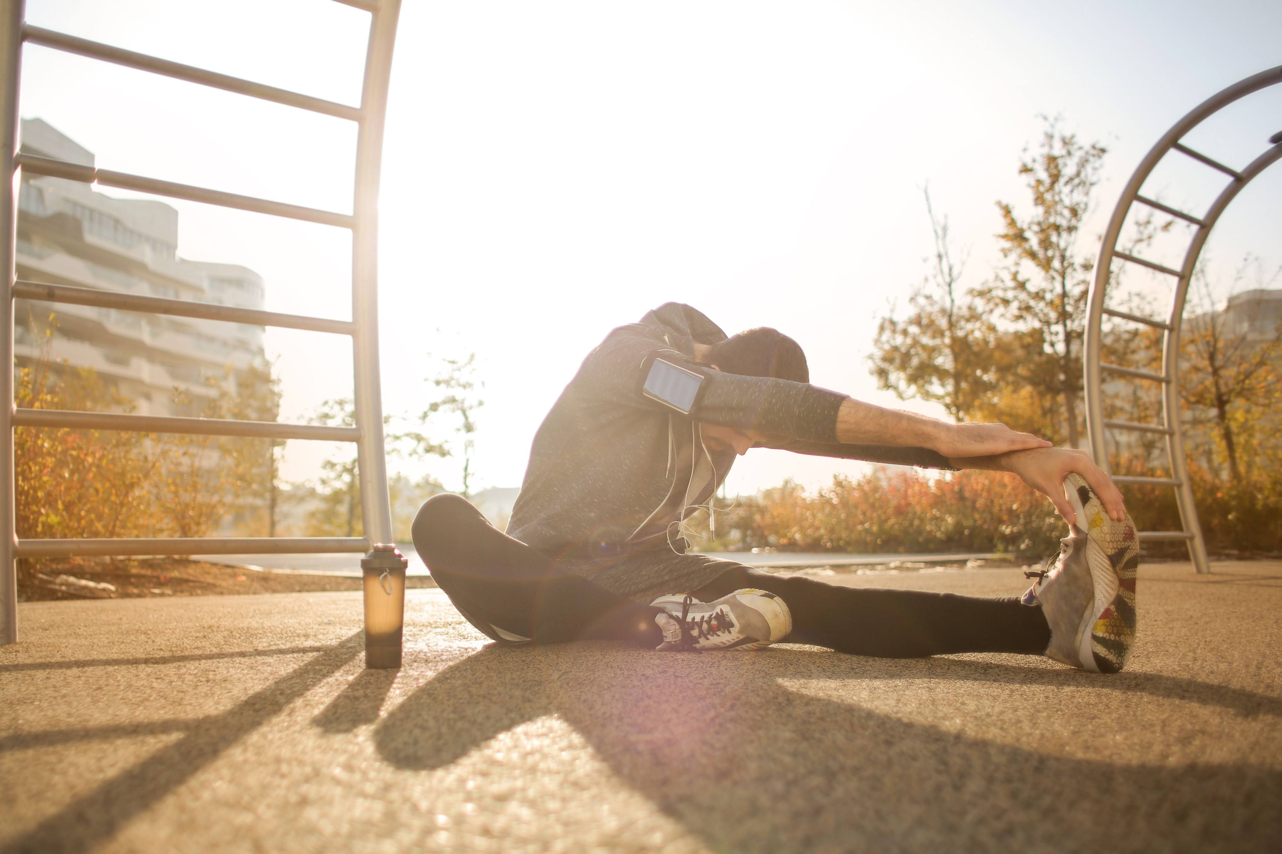 Athlete stretching outdoors at golden hour